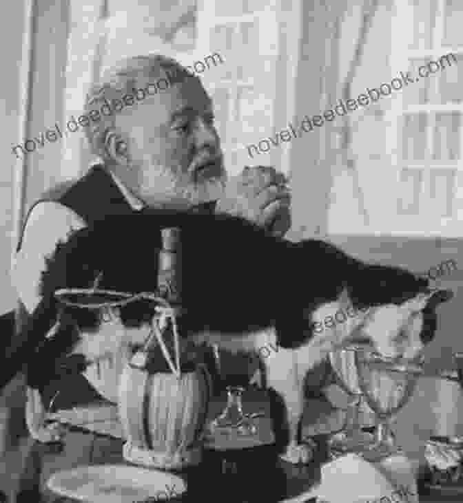 A Black And White Photo Of Ernest Hemingway Holding A Cat. Cherished: 25 Writers On Animals They Have Loved And Lost